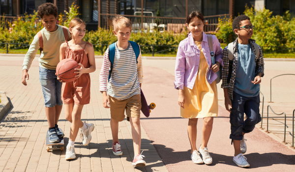 Children walking or riding skateboards to school